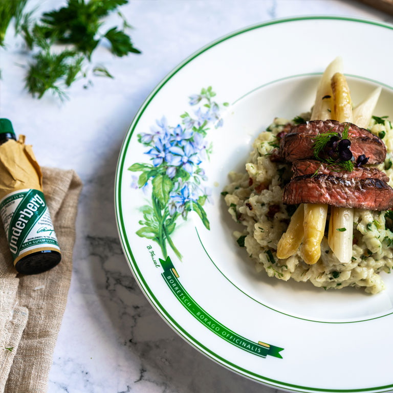 Herbbacon risotto with white asparagus and beef strips Underberg Dansk