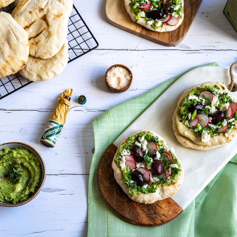 Grilled flat bread with guacamole, herbs, olives and feta